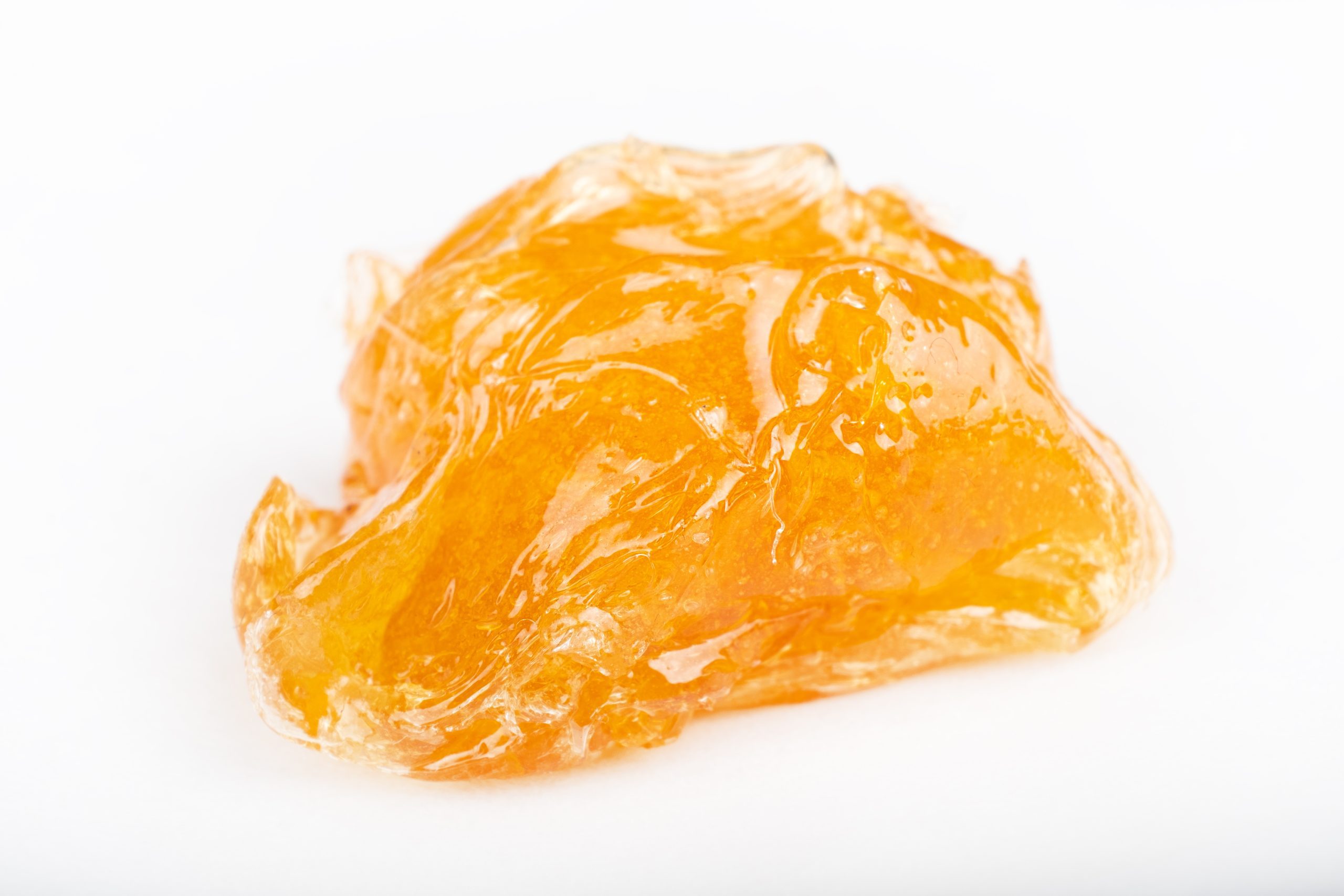 yellow wax piece with high cannanis badder isolated on white background.